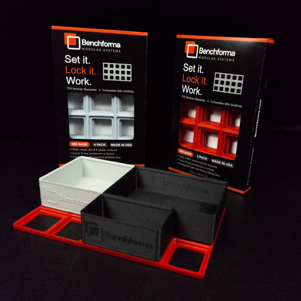 Demonstration of Benchforma Baseplate and Bin that are compatible with Gridfinity. Black and Red TPE Baseplate packaging shown in background
